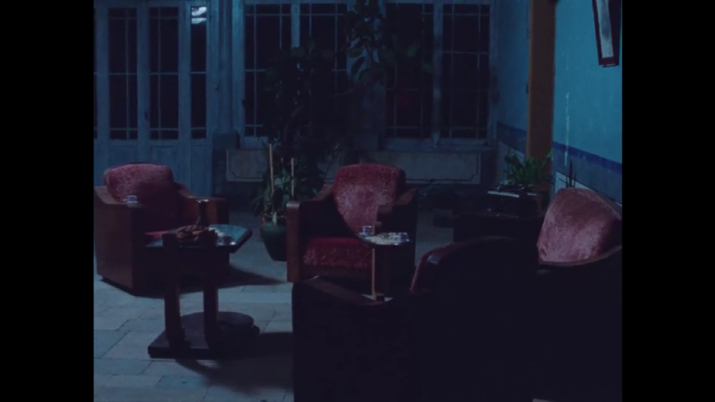 The blue light of night illuminates a well-furnished sitting room, empty of people. It feels hollow and lifeless.