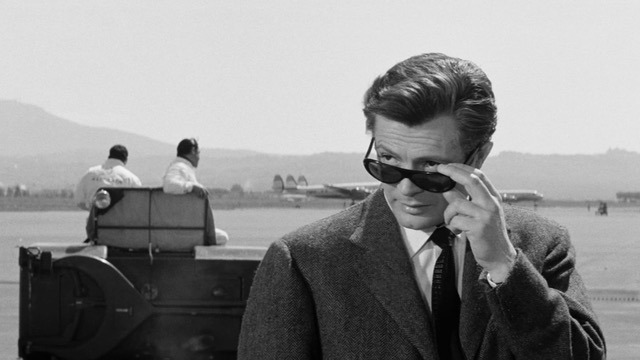 black-and-white image of a dark-haired man wearing sunglasses