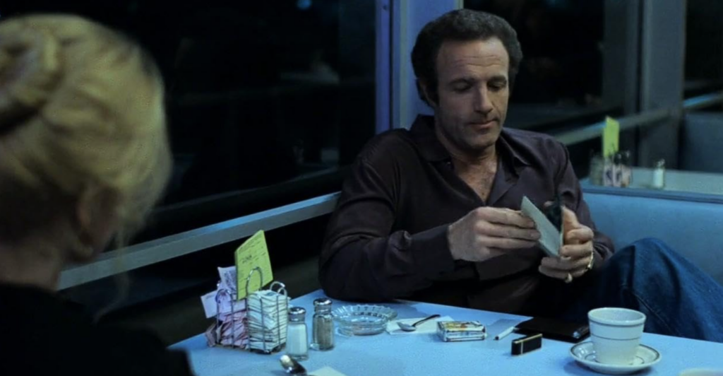 Frank and Jessie sit across from each other at a diner table.