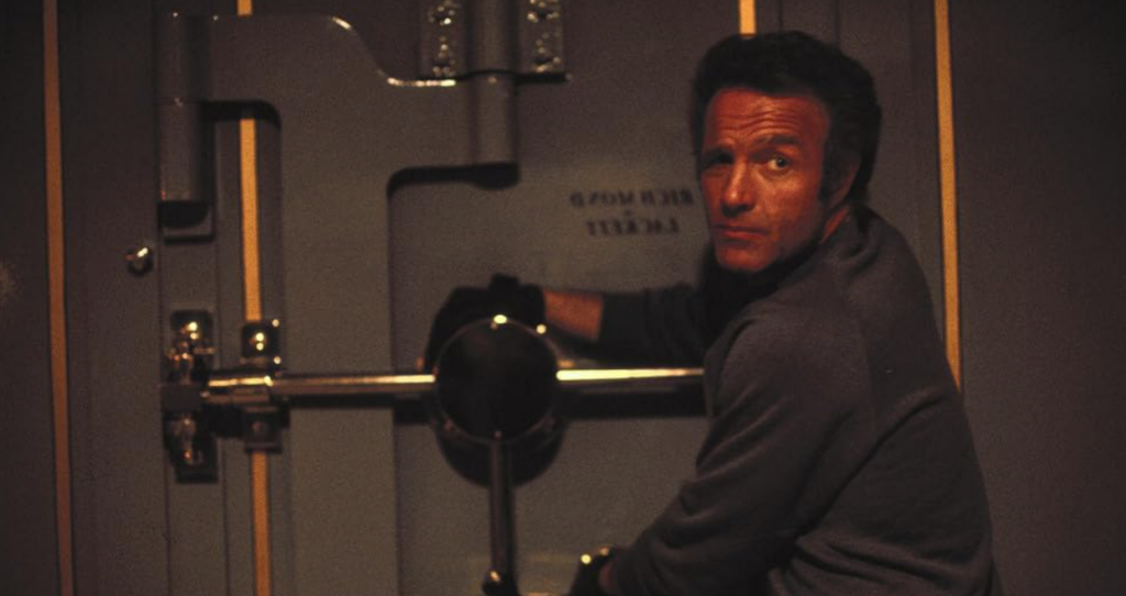 James Caan as Frank looks into the camera as he works on a robbery.