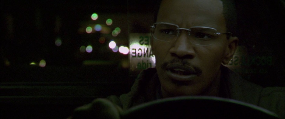 A cab driver driving his car at night.