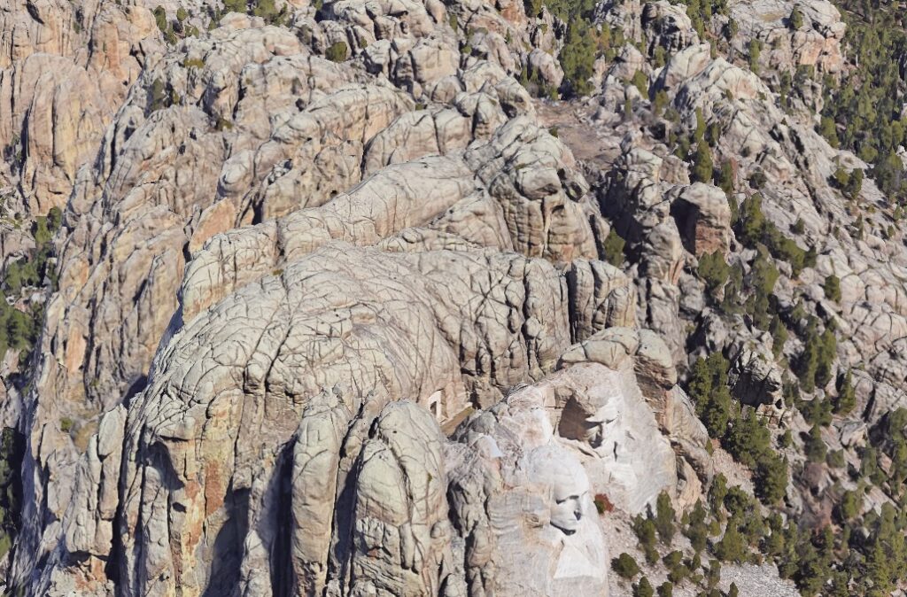 Googe Earth image of the craggy and mountainous area surrounding Mt Rushmore. Clearly no flat enough space for a runway long enough for a plane to take off from.