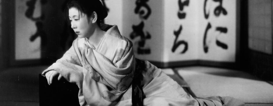 Oharu (Kinuyo Tanaka) laying with a somber look on her face.