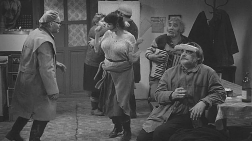 Villagers dance in a decrepit tavern.