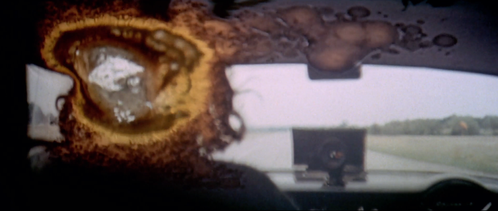 The final shot of the movie with a big burnout splotch in the film covering the back of the head of The Driver as the film melts in the projector.