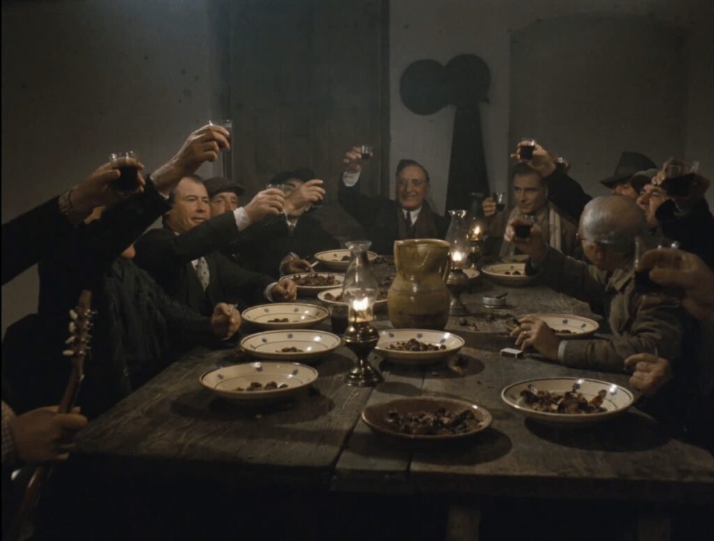 eleven white men seated around a dinner table, toasting.