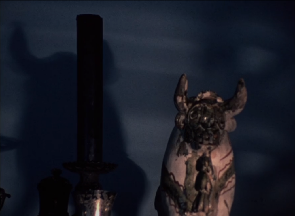 There is a strange bull sculpture to the right, which casts a giant horned shadow on the left.